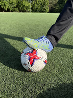 Close-up of Strykr Flight Pro official size 5 match soccer ball under player's cleat
